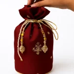 Maroon Potli With Golden Bunch For Her