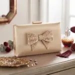 Elegance Shimmer Bow Clutch In Golden